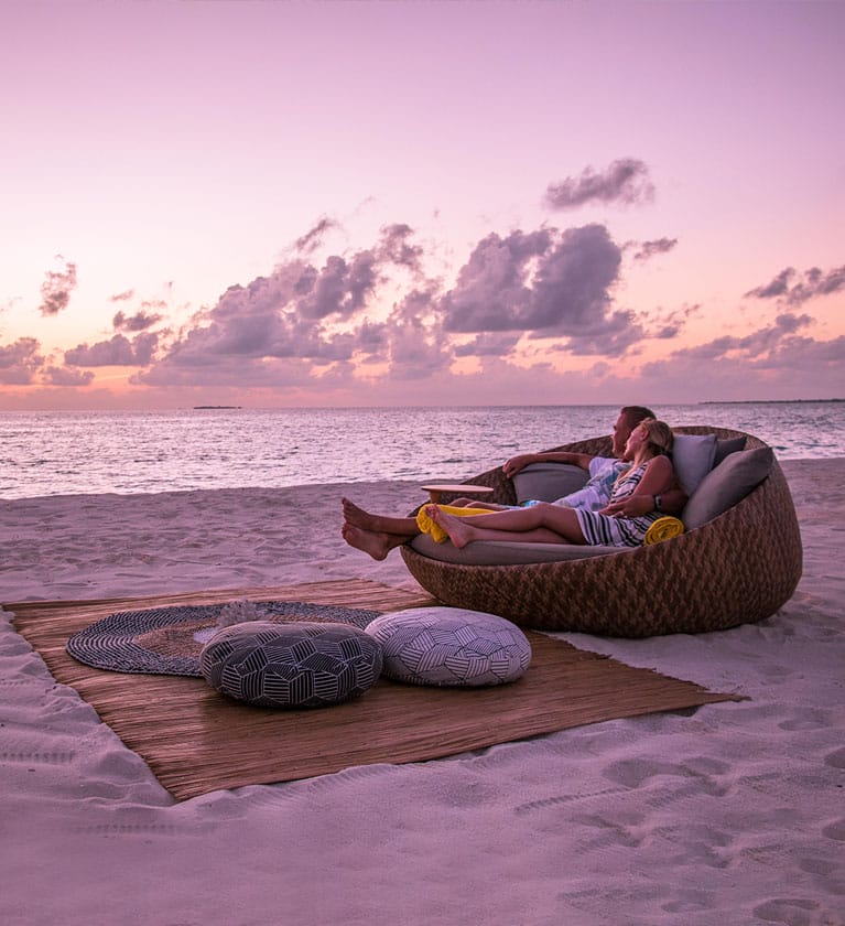 A couple enjoying a night with under the stars with an ocean view